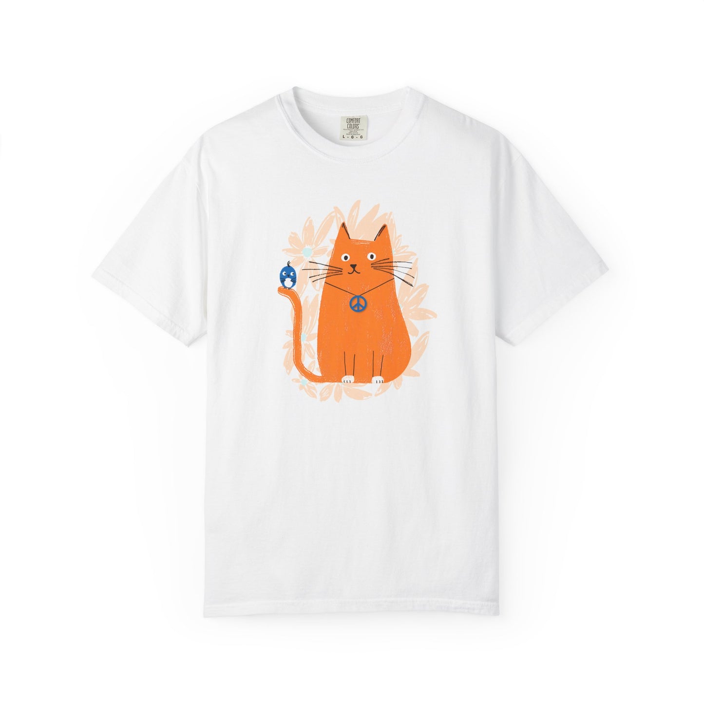 A white t-shirt featuring an orange cat wearing a "peace" sign necklace; perched on the cat's tail is a cute blue bird. A spray of pale orange flowers in the background.