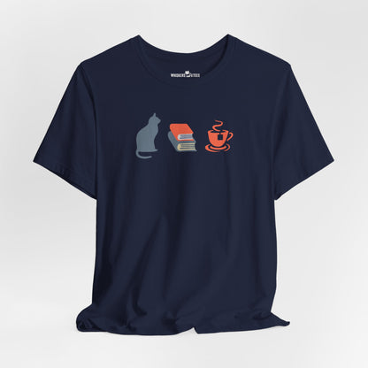 navy blue graphic tee showing a powder-blue cat, orange and blue books, and orange tea cup