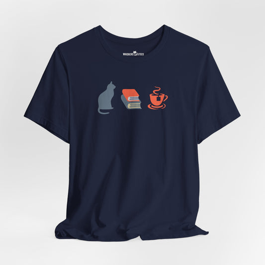 navy blue graphic tee showing a powder-blue cat, orange and blue books, and orange tea cup