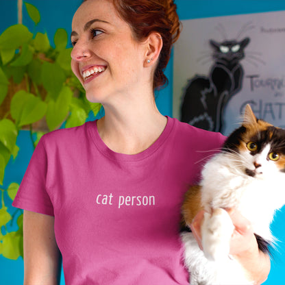 smiling woman wearing a pink t-shirt with words 'cat person' printed in white