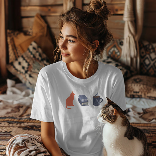 Woman wearing a white t-shirt with orange cat, blue books, dark blue steaming coffee mug